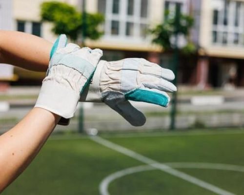 action-shot-of-sports-gloves-ready-for-play-on-a-sunny-soccer-field-photo